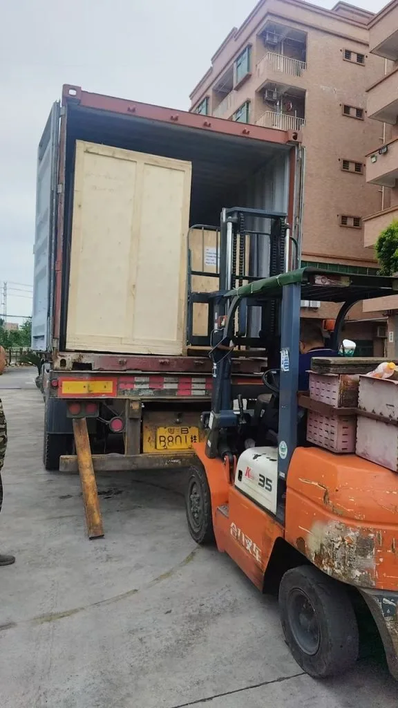 Actual footage of forklift operations loading equipment for export orders into shipping containers; after the units are secured, they are loaded one by one into the containers by forklifts.