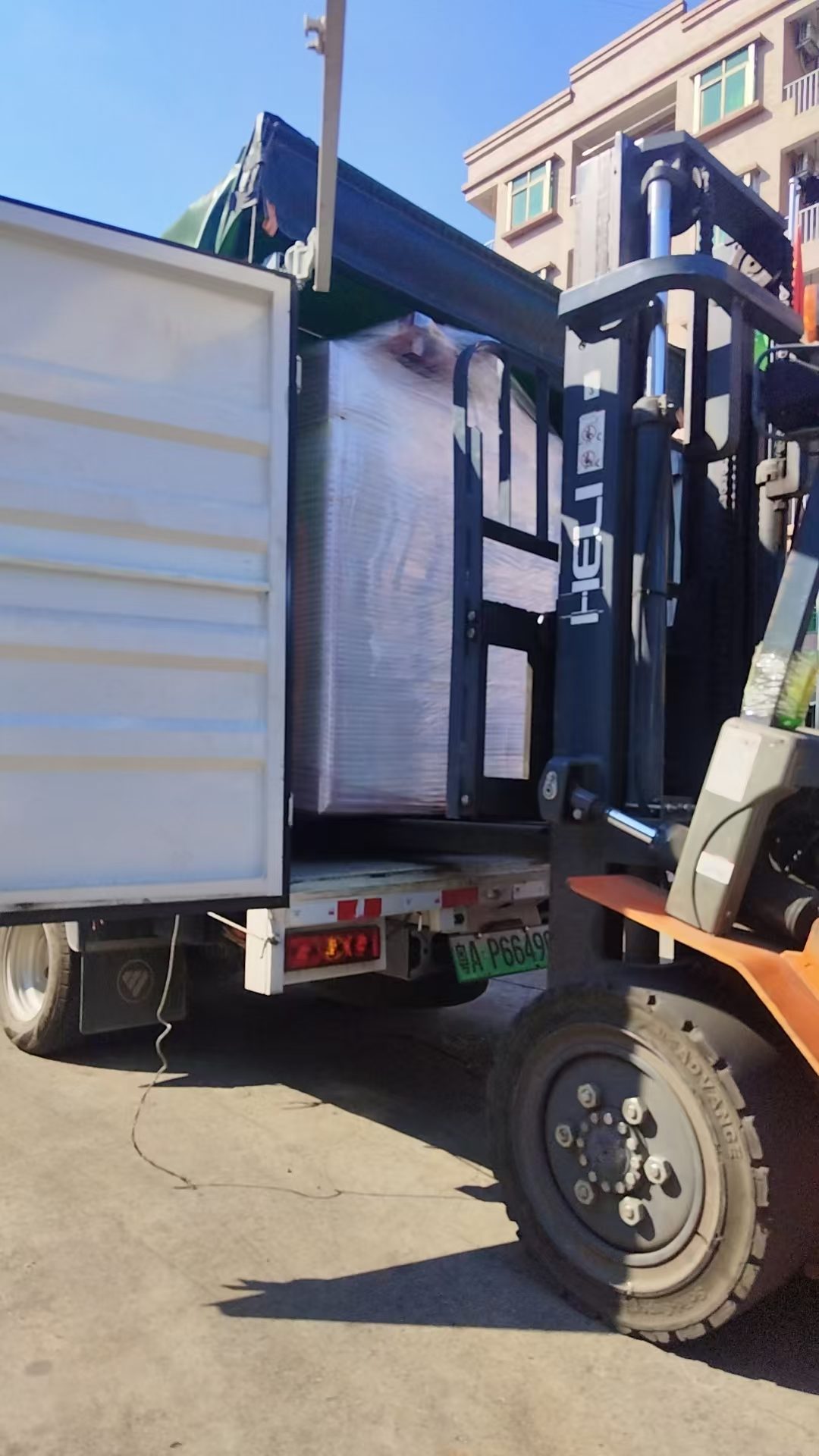 A forklift loads a sublimation drum printer destined for export to Shenzhen
